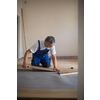 DIY, repair, building and home concept - Senior landlord lying parquet floor board/laminate flooring in a rental appartement (shallow DOF; color toned image)