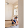 DIY, repair, building and home concept - senior man lying parquet floor board/laminate flooring (shallow DOF; color toned image)