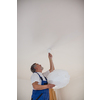 DIY, repair, building and home concept - senior landlord hanging a new light(shallow DOF; color toned image)