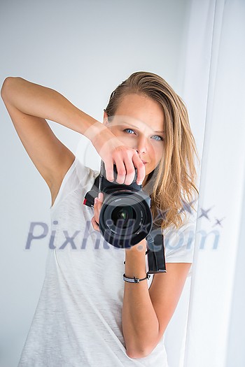 Pretty, female photographer with digital camera (color toned image; shallow DOF) Pretty, female photographer with digital camera (color toned image; shallow DOF)