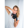 Pretty, female photographer with digital camera (color toned image; shallow DOF)