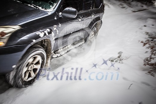 Motion blurred image of a big suv car going fast on a snow covered forest road Motion blurred image of a big suv car going fast on a snow covered forest road