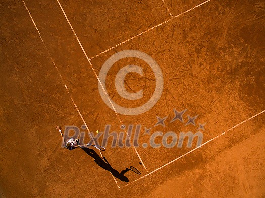 Female tennis player on the court. Wide angle view from above with plenty of copyspace Female tennis player on the court. Wide angle view from above with plenty of copyspace
