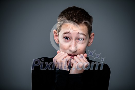 Grief-stricken little boy - feeling intense sorrow, remorse, sadnesss - studio portrait - vivid emotions series