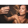 Happy mid-aged woman taking selfie with her smart phone at home