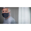 Senior man wearing  a facemask during coronavirus and flu outbreak. Virus and illness protection, home quarantine. COVID-19 concept
