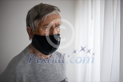 Senior man wearing a facemask during coronavirus and flu outbreak. Virus and illness protection, home quarantine. COVID-19 concept Senior man wearing a facemask during coronavirus and flu outbreak. Virus and illness protection, home quarantine. COVID-19 concept