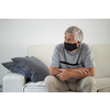 Senior man wearing  a facemask during coronavirus and flu outbreak. Virus and illness protection, home quarantine. COVID-19 concept