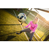 Teen female goalie catching a shot during a soccer game