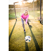 Teen female goalie catching a shot during a soccer game