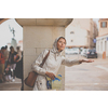 Gorgeous female tourist with a map discovering a foreign city - waiting for the rain to stop (shallow DOF; color toned image)