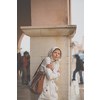 Gorgeous female tourist with a map discovering a foreign city - waiting for the rain to stop (shallow DOF; color toned image)