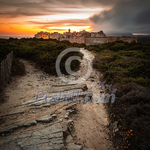 Sunset and storm over the Old Town of Bonifacio, the limestone cliff, South Coast of Corsica Island, France