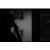 Mid-aged woman lighting a cigarette at home, getting her nicotine daily dose