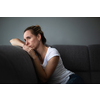 Depressed mid-aged woman at home feeling sad, lonely, anxious (color toned image)