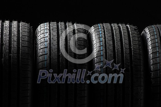 Stack of brand new high performance car tires on clean high-key white studio background Stack of brand new high performance car tires on clean high-key white studio background