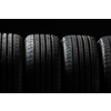Stack of brand new high performance car tires on clean high-key white studio background