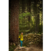 Pretty, young female hiker walking through a splendid old forest (shallow DOF)