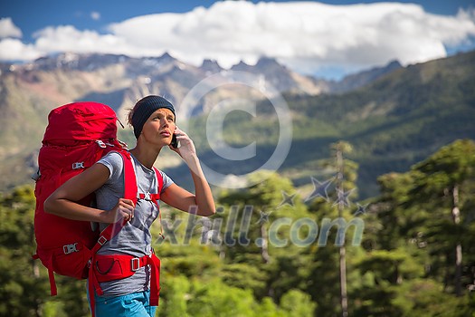 Pretty, female hiker in high mountains , calling for help - being injured and lost Pretty, female hiker in high mountains , calling for help - being injured and lost