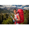 Pretty, female hiker in high mountains using a map to find a way through a mountain range