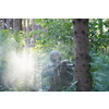 modern warfare soldier in action aiming at weapon  laser sight optics  in combat position while searching for a target in battle