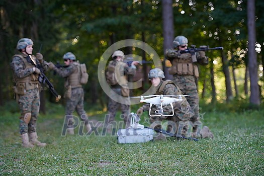 Modern Warfare Soldiers Squad are Using Drone for Scouting and Surveillance During Military Operation in the Forest. Modern Warfare Soldiers Squad are Using Drone for Scouting and Surveillance During Military Operation in the Forest.