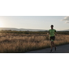 triathlon athlete running  on morning training sunrise in the background