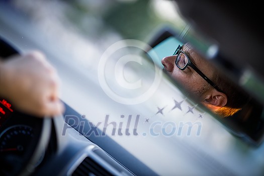 Handsome young driver driving hic car fast yet safely on the road Handsome young driver driving hic car fast yet safely on the road