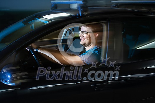 Handsome young driver driving hic car fast yet safely on the road Handsome young driver driving hic car fast yet safely on the road