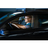 Handsome young driver driving hic car fast yet safely on the road