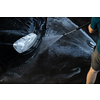 Young man washing his beloved car carefully in a manual car wash to prevent any damage and detail it properly