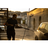 Young man washing his beloved car carefully in a manual car wash to prevent any damage and detail it properly