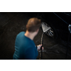 Young man washing his beloved car carefully in a manual car wash to prevent any damage and detail it properly