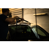 Young man washing his beloved car carefully in a manual car wash to prevent any damage and detail it properly