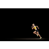 Young woman athlete running fast on dark background 
