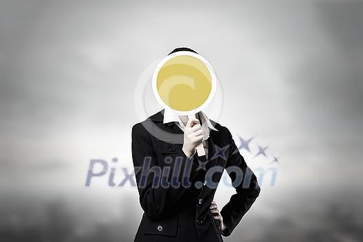 Unrecognizable businesswoman hiding her face behind mask Unrecognizable businesswoman hiding her face behind mask