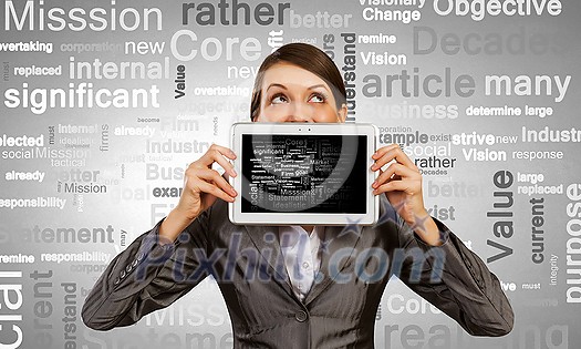 Beautiful young woman holding tablet pc against her mouth Beautiful young woman holding tablet pc against her mouth