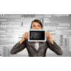 Beautiful young woman holding tablet pc against her mouth