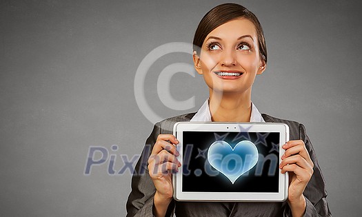 Beautiful young woman holding tablet pc with love heart Beautiful young woman holding tablet pc with love heart