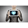 Beautiful young woman holding tablet pc with love heart