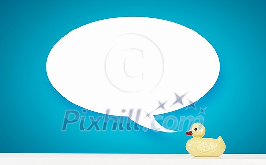 Yellow rubber duck toy on table with speech bubble Yellow rubber duck toy on table with speech bubble
