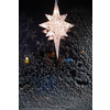 Typical star for lightning in the window and decoration during the winter time for Christmas in Scandinavia. The star is meant to represent the Star of Bethlehem,  birth of JesusA Christmas star in the window. Warm light, Christmas, cosy atmosphere. Advent time.