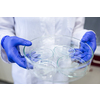Hands of a female researcher carrying out research in a chemistry lab (color toned image; shallow DOF)