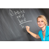 Pretty young college student or teacher washing the chalkboard/blackboa rd during class (shallow DOF; color toned image)