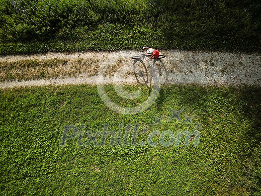 Pretty, young woman riding her mountain bike on a forest path. Enjoying active leisure time outdoors. Pretty, young woman riding her mountain bike on a forest path. Enjoying active leisure time outdoors.