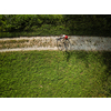 Pretty, young woman riding her mountain bike on a forest path. Enjoying active leisure time outdoors.