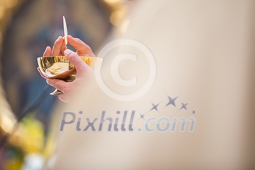 Priest during a wedding ceremony/nuptial mass (shallow DOF; color toned image) Priest during a wedding ceremony/nuptial mass (shallow DOF; color toned image)