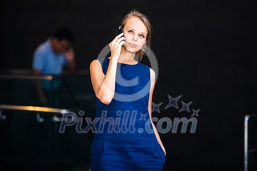 Pretty, young businesswoman talking on the phone in front of a modern building in Manhattan (shallow DOF; color toned image) Pretty, young businesswoman talking on the phone in front of a modern building in Manhattan (shallow DOF; color toned image)