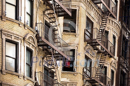 Old apartment building with fire escapes, Manhattan, New York City Old apartment building with fire escapes, Manhattan, New York City