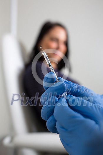 Patient getting a vaccine shot from a doctor/nurse against a virus during a virus pandemic Patient getting a vaccine shot from a doctor/nurse against a virus during a virus pandemic
